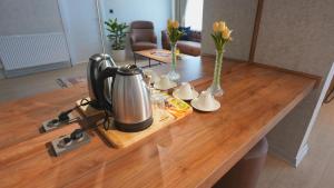 a table with a tea kettle and vases on it at One way in Kayseri