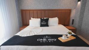 a bed with a one way hotel sign on it at One way in Kayseri