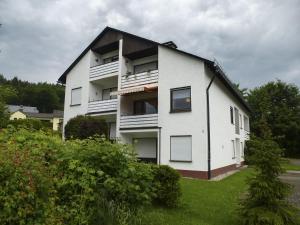 a white apartment building with a black roof at Fewo Jäger in Willingen