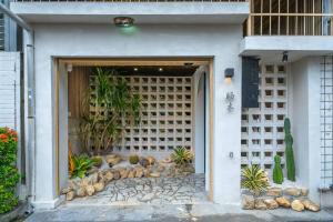 a facade of a house with plants in it at Tainan Sunwood B&B in Anping