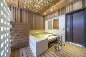 a bathroom with a bath tub in a room at Tainan Sunwood B&B in Anping +22 photos