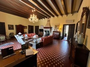 a living room filled with furniture and a chandelier at Casa Aguilar-Habitaciónes y más en casa exclusiva en Centelles in Centellas