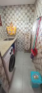 a bathroom with a sink and a washing machine at Residencial Villa Jeri - AP with balcony, optional BREAKFAST in Jericoacoara