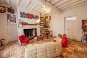a living room with a couch and a fireplace at Castel La Fabrik'Créative in Saint-Barthélémy-dʼAgenais