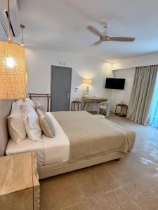 a bedroom with a large bed and a table at Absolute Paradise Santorini in Akrotiri +66 photos