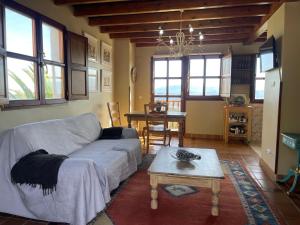 a living room with a couch and a table at Alojamientos Rurales Peña Crespa in Tresvilla