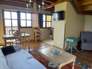 a living room with a couch and a table at Alojamientos Rurales Peña Crespa in Tresvilla +141 photos