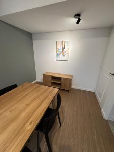 a room with a wooden table and a painting on the wall at Departamento Sancor in Santa Fe