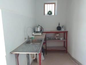 a small kitchen with a sink and a counter at Caraz - Cozy Cottage in Caraz