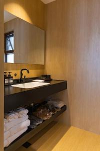 a bathroom with a sink and a mirror and towels at year after year in Lijiang +80 photos