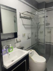 a bathroom with a toilet and a sink and a shower at Phu Long Mermaids Hostel in Phù Long
