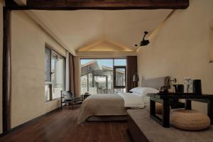 a bedroom with a bed and a large window at year after year in Lijiang