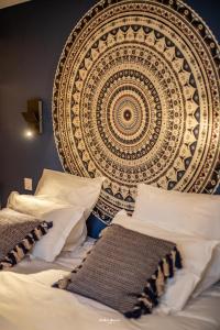a large tapestry above a bed in a bedroom at Les Chalets de Seignou in Azet