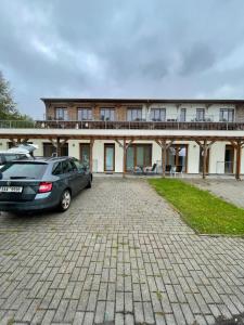 a car parked in a parking lot in front of a building at Serenity Lipno in Lipno nad Vltavou