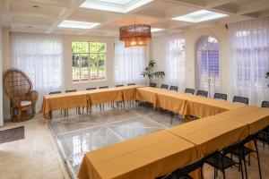 a conference room with tables and chairs and a chandelier at MiraNamin M A P I L I G Suite in Unique Historic Home - Shared Kitchen, Rooftop in Manila +26 photos