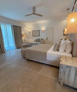 a bedroom with a large bed and a couch at Absolute Paradise Santorini in Akrotiri