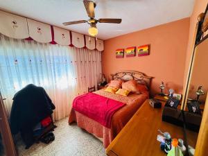 a bedroom with a bed and a ceiling fan at RG Mostoles in Móstoles