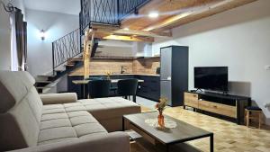 a living room with a couch and a table and a kitchen at Villa Roko in Ličko Lešće