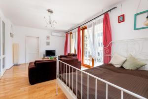 a living room with a bed and a couch at GRAND ADVENTURE BUDAPEST in Budapest