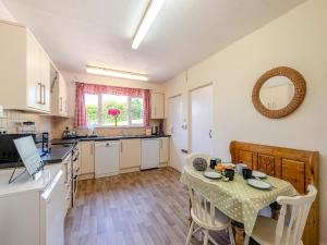 a kitchen with a table and a dining room at Tara in Kingsbridge