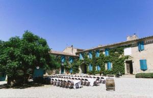 a group of tables in front of a building at Les chambres du domaine de russol in Laure-Minervois