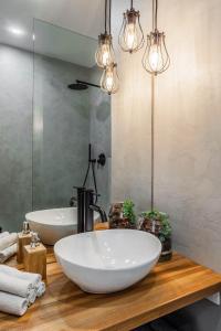 a bathroom with two white sinks and a mirror at K24 - Old Town Luxury Apt in Bratislava