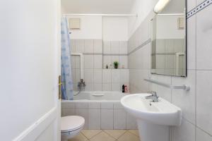 a bathroom with a sink and a toilet and a tub at GRAND ADVENTURE BUDAPEST in Budapest +8 photos