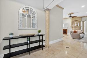 a living room with a table and a chair at Hollywood Crest by Rove - 4BR Home with Heated Pool in Hollywood Beach
