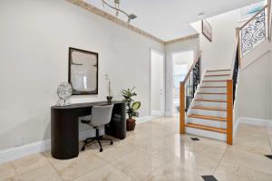 a home office with a desk and a mirror at Hollywood Crest by Rove - 4BR Home with Heated Pool in Hollywood Beach
