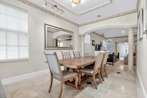 a dining room with a wooden table and chairs at Hollywood Crest by Rove - 4BR Home with Heated Pool in Hollywood Beach +48 photos