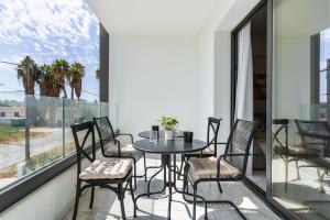 a balcony with a table and chairs and a window at Vervana 2-Bedroom Apartment in Larnaca