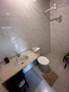 a bathroom with a sink and a toilet at Cabana Americana in Mairiporã +34 photos