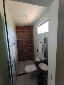a bathroom with a toilet and a sink at Bendita Parada - Pousada in Sobral +18 photos