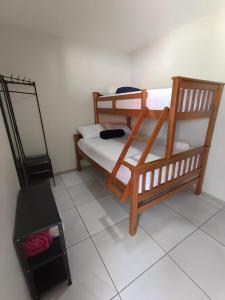 a bedroom with two bunk beds and a mirror at Bendita Parada - Pousada in Sobral +18 photos