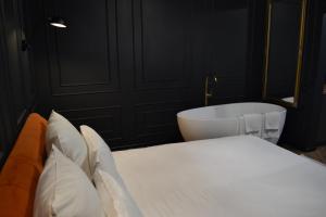 a bedroom with a bed and a bath tub at Central Gate apartment in Chernivtsi