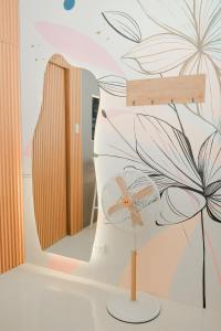 a fan in front of a wall with a flower mural at N Residences in Puerto Princesa City