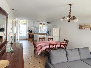 a living room with a table and a couch at La poterie in Castets