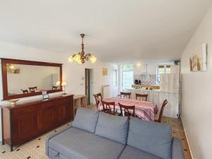 a living room with a couch and a table at La poterie in Castets