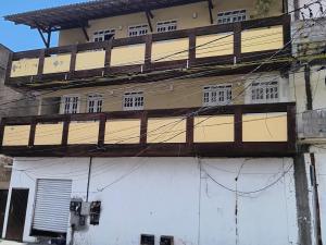 a building with wooden balconies on the side of it at Espaço Zen in Camaçari