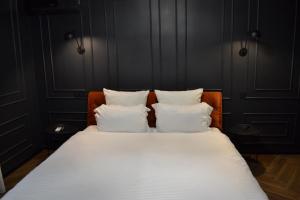 a bed with two white pillows on top of it at Central Gate apartment in Chernivtsi