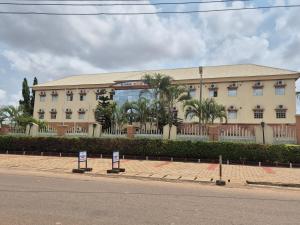 a building with two signs in front of it at Al-ihsan Metro Hotel in Kaduna