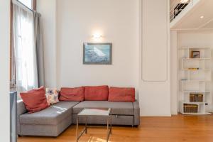 a living room with a couch and a table at The great window by Toh Solution in Turin