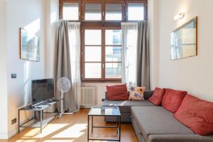 a living room with a couch and a tv at The great window by Toh Solution in Turin +63 photos