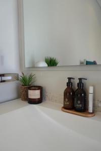 a shelf with two bottles of soap and a mirror at Pine Villa 3 bed with pool Pine Villa in Tokai
