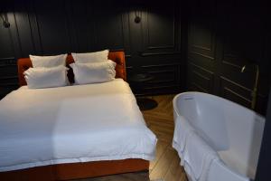 a bedroom with a bed and a bath tub at Central Gate apartment in Chernivtsi +20 photos