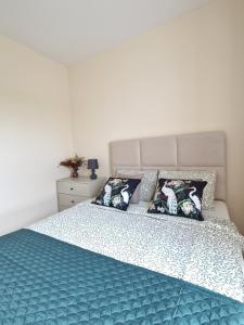 a bedroom with a large bed with blue sheets and pillows at Apartament Potockiego Private Parking Faktura in Rzeszów