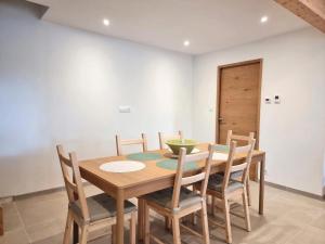 a dining room with a wooden table and chairs at L'Ecole Buissonnière de Mazalibrand in Bronac