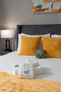 a white bed with towels and pillows on it at Cozy Lux Haven Whitestown in Whitestown