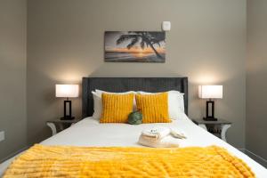 a bedroom with a large bed with yellow pillows at Cozy Lux Haven Whitestown in Whitestown