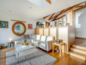 a living room with a couch and a table at Shore House in Kilcreggan